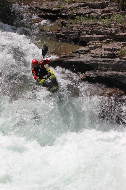 whitewater kayaker tackles waterfall