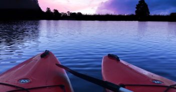 two kayaks on the water at sunset